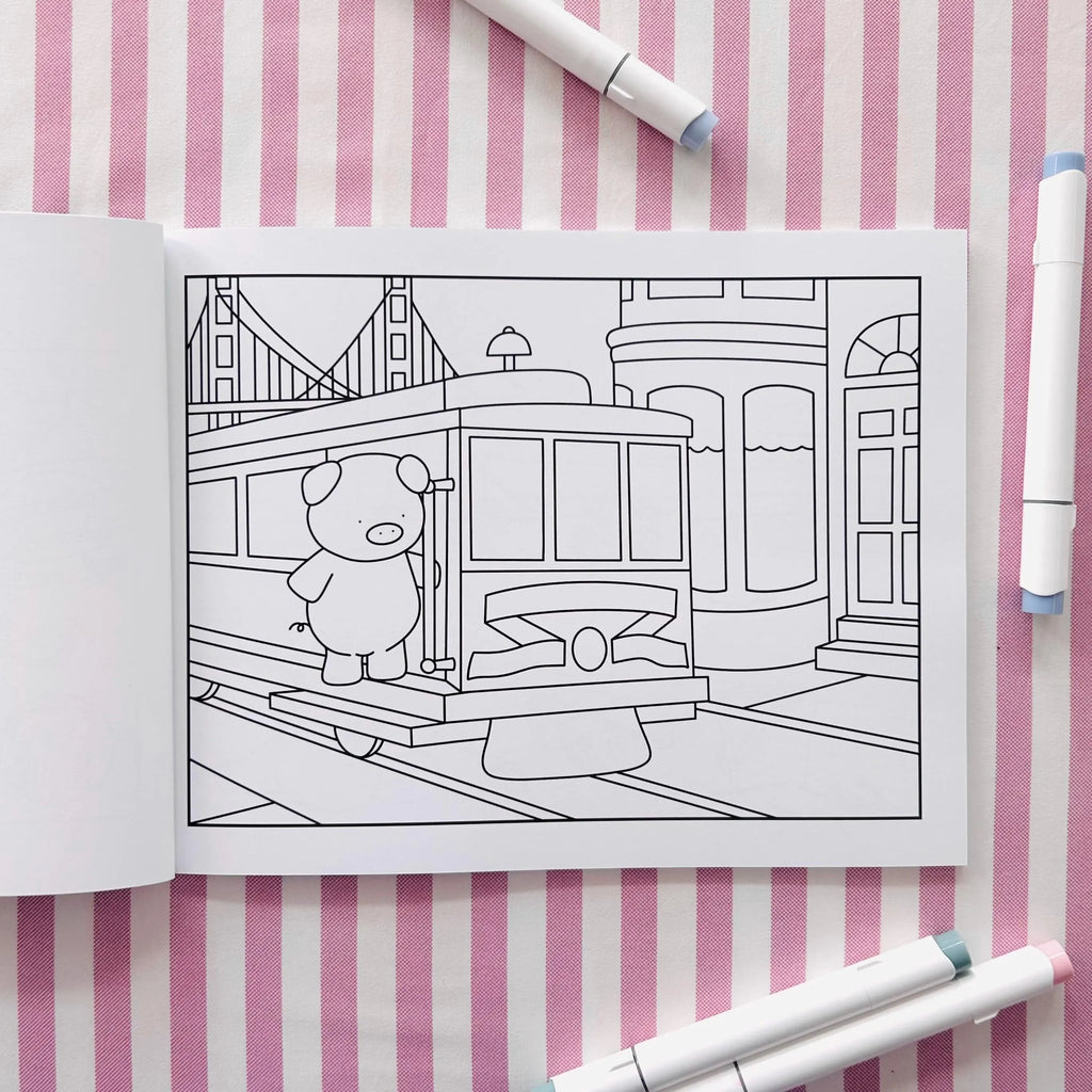 Open coloring book page of a pig riding a San Fransisco trolley car.